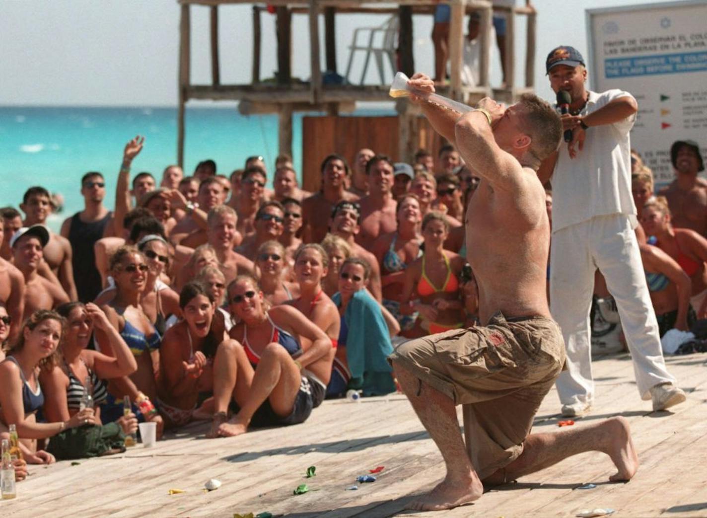 Kevin Elgee, a Massachussett college student, in Cancun for spring break, downs a beer in an afternoon guzzling contest on the beach in front of the Oasis hotel. The crowd included several Twin Cities high school students also on spring break.