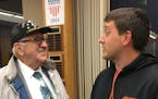 Resident Malcolm Watson (left) congratulates incoming Council Member Nick Novitsky (right) on his appointment after Monday night's meeting.