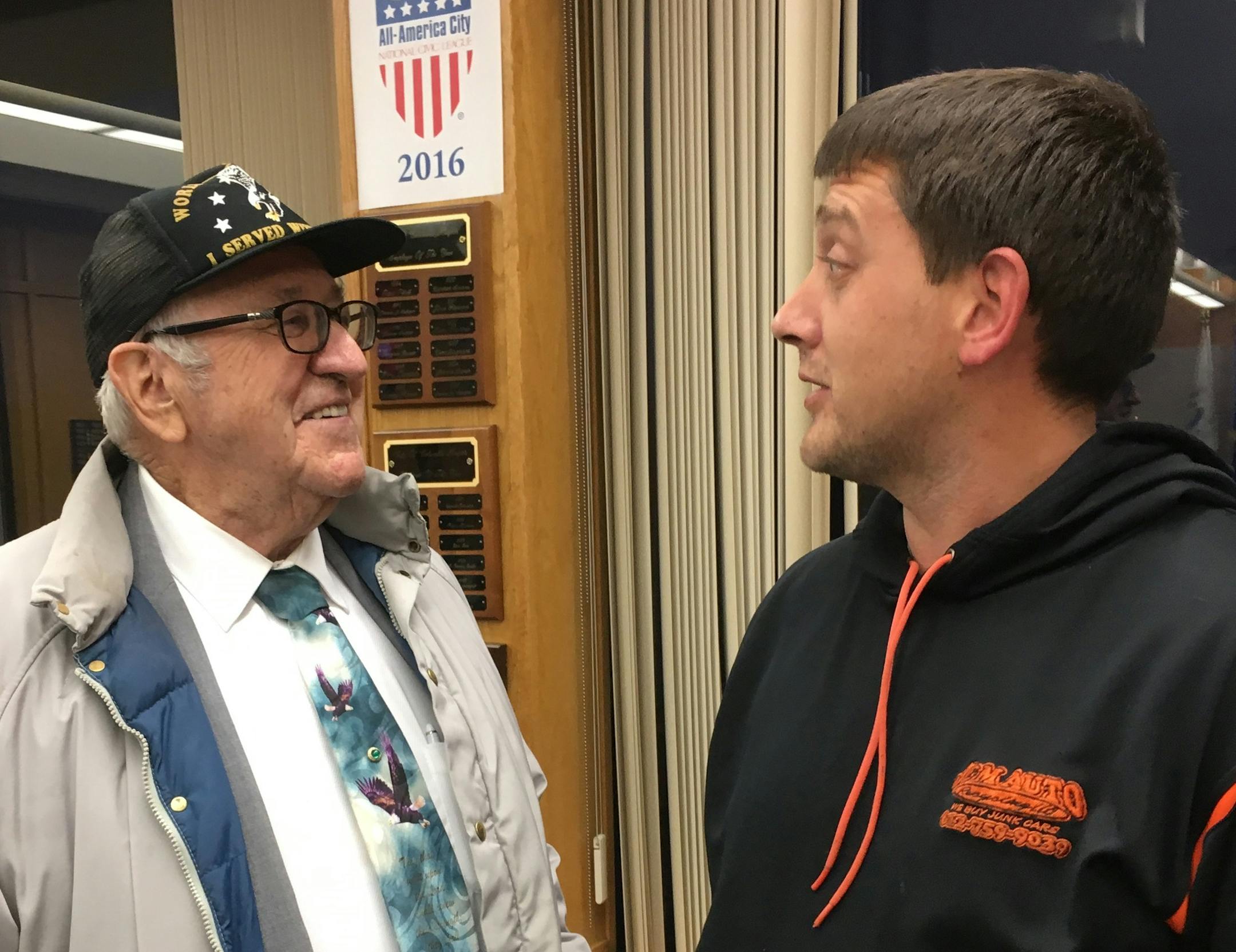 Resident Malcolm Watson (left) congratulates incoming Council Member Nick Novitsky (right) on his appointment after Monday night's meeting.