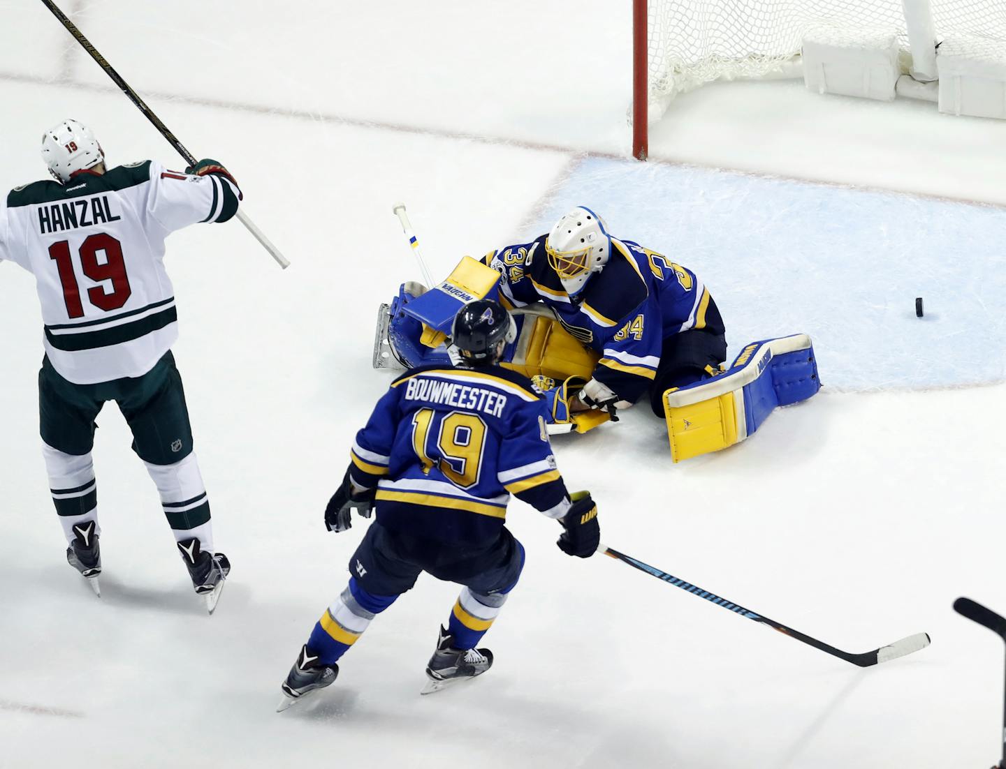 Minnesota Wild&#x2019;s Martin Hanzal, left, of the Czech Republic, celebrates after scoring past St. Louis Blues goalie Jake Allen (34) and Blues&#x2019; Bouwmeester during the second period in Game 4 of an NHL hockey first-round playoff series Wednesday, April 19, 2017, in St. Louis. (AP Photo/Jeff Roberson)