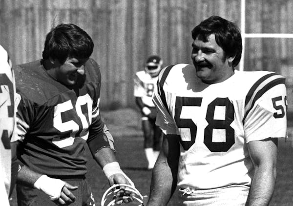 September 25,1980 Vikings newcomer Jim Langer, right, exchanged quips with linebacker Jeff Siemon at at practice Wednesday. The two opposed each other