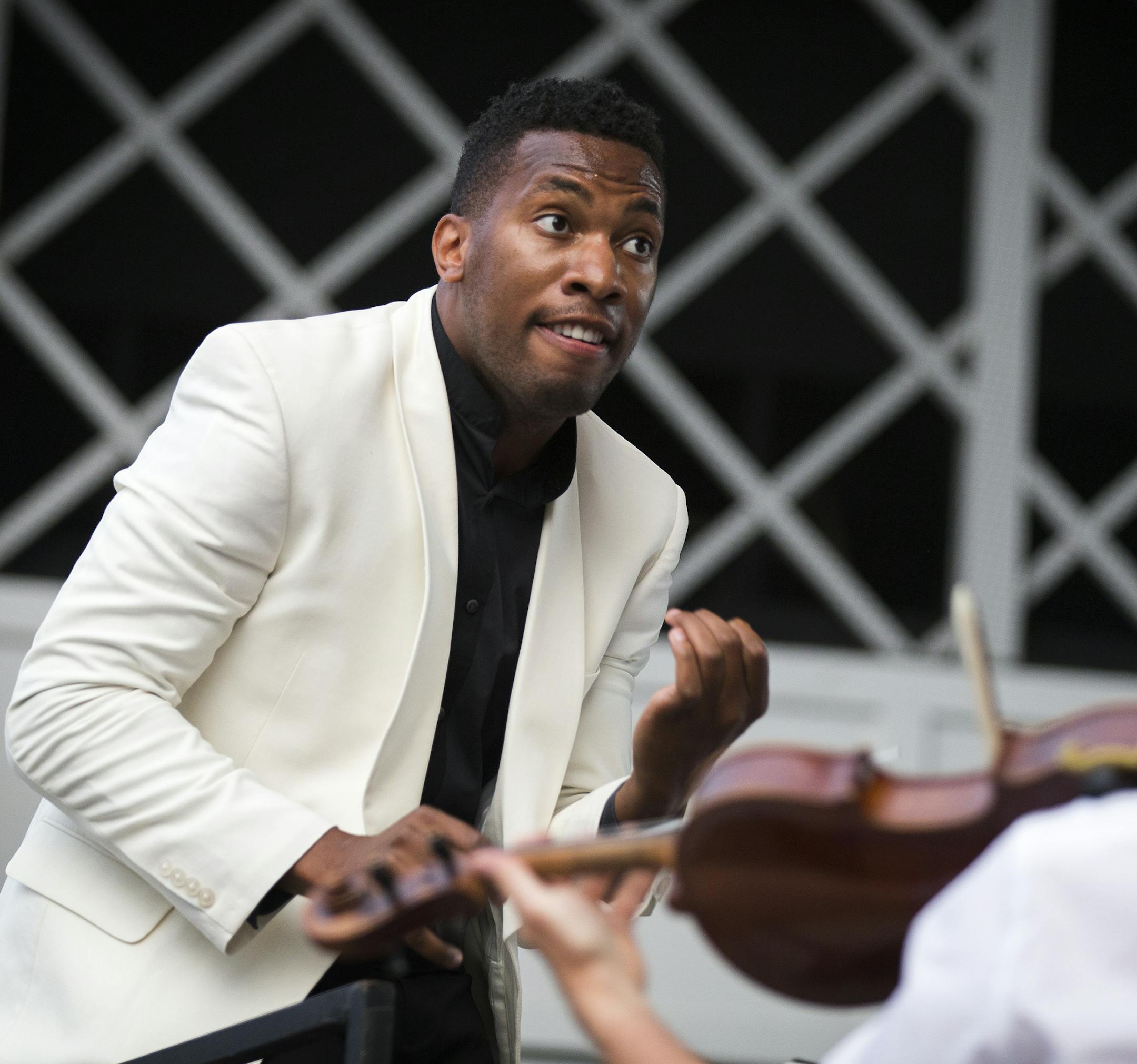 Roderick Cox conducts the Minnesota Orchestra during their Symphony for the Cities performance at the Lake Harriet Bandshell in Minneapolis on Monday, June 29, 2015. ] LEILA NAVIDI leila.navidi@startribune.com / BACKGROUND INFORMATION: Every year the Minnesota Orchestra presents a series of free outdoor concerts called Symphony for the Cities. Other Symphony for the Cities performances: -Wednesday, July 1 at the Hilde Performance Center in Plymouth -Thursday, July 2 at the Winona Lake Park Bands