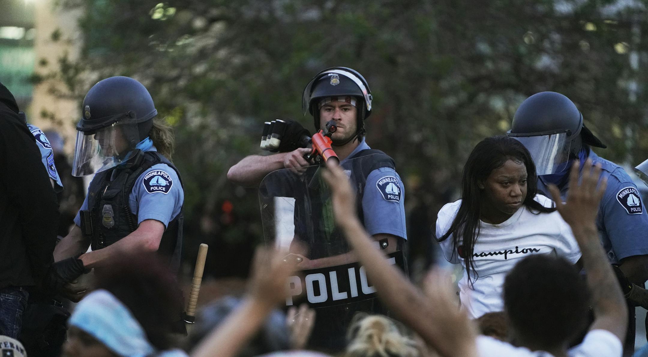 Police officers detain people as they try to control a protest in Minneapolis on Sunday, May 31, 2020. Protests were held in U.S. cities over the death of George Floyd, a black man who died after being restrained by Minneapolis police officers on May 25. (Richard Tsong-Taata/Star Tribune via AP)