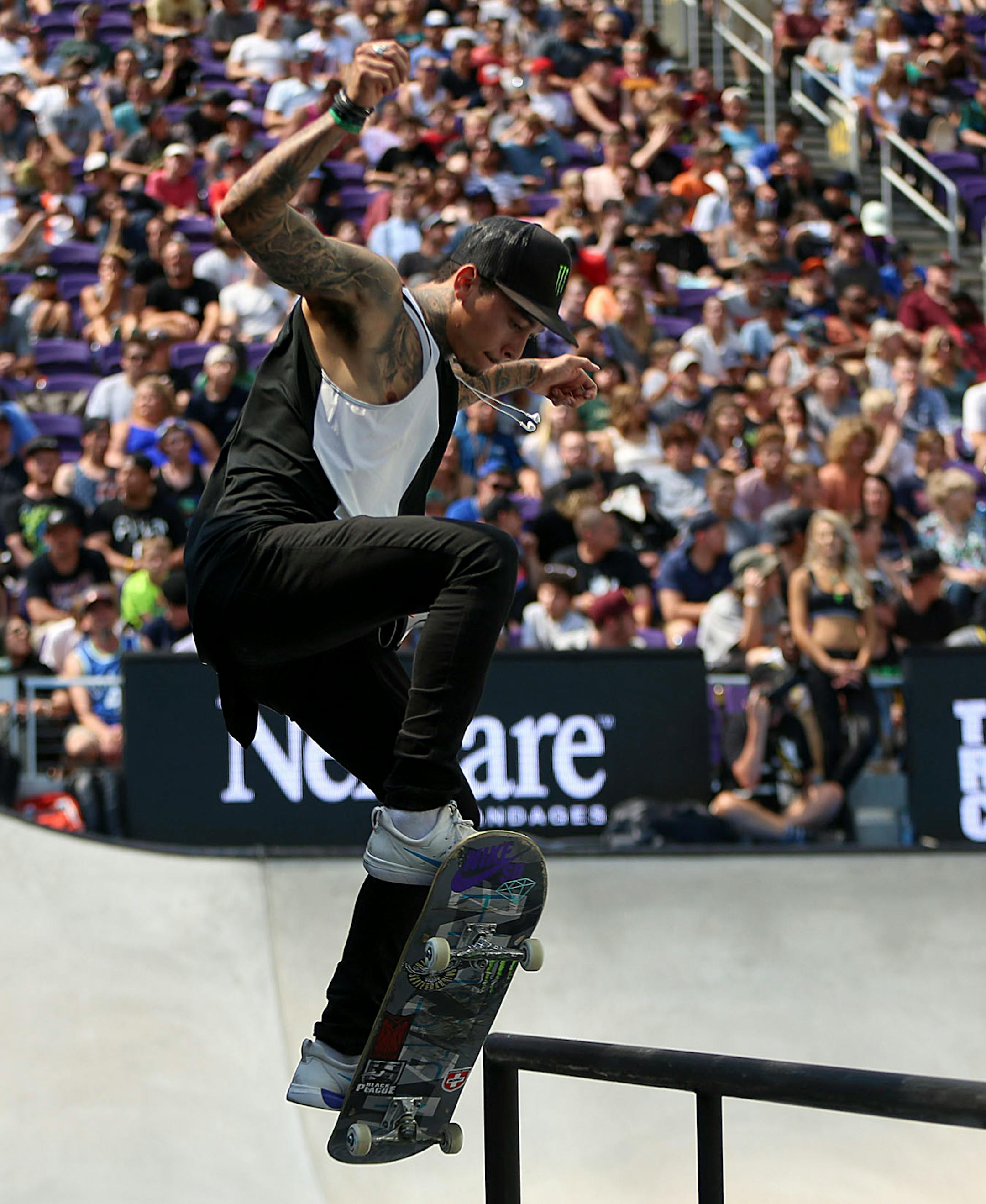 Nyjah Huston, the eventual gold medal winner, pulls off a trick in the men's skateboard street final.