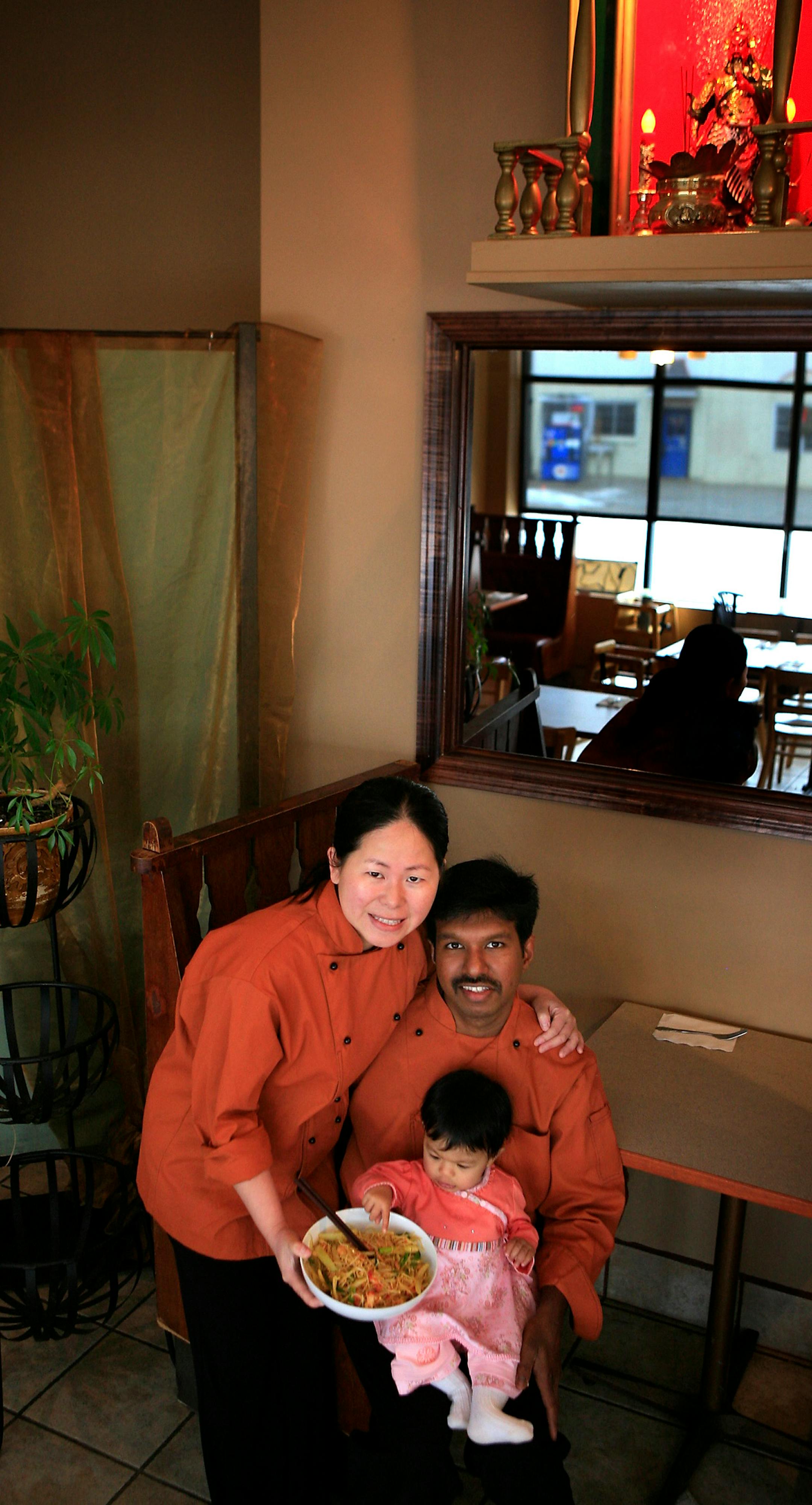Nina Wong, left, and Thomas and Tia Gnanapragasam, daughter, 10 months, pose in their restaurant the ChinDian Cafe on East Hennepin.