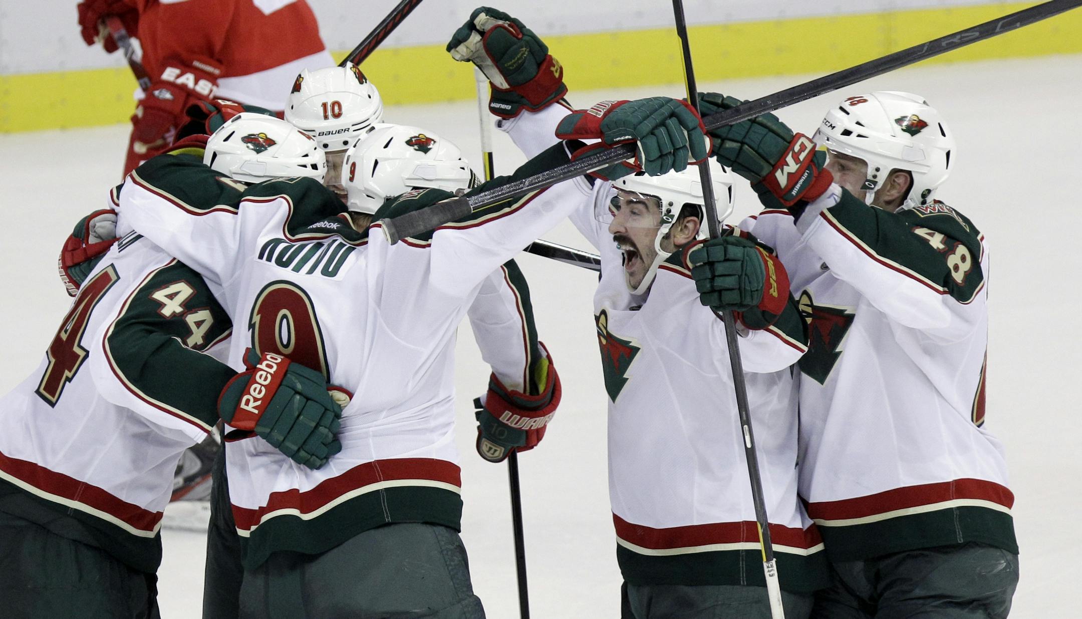 From left, the Wild's Justin Falk, Mikko Koivu, Devin Setoguchi, Cal Clutterbuck and Guillaume Latendresse celebrated Koivu's goal with a minute remaining in regulation on Tuesday.