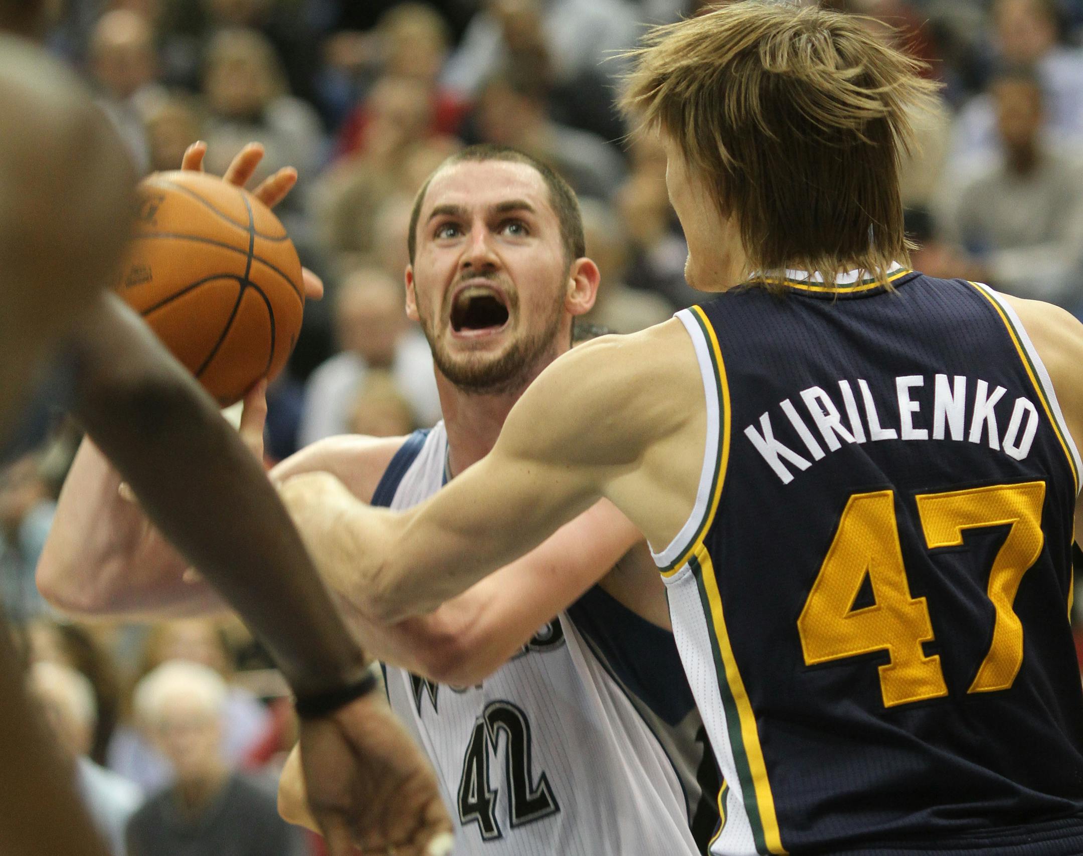 Andre Kirilenko guards Kevin Love in December 2010.