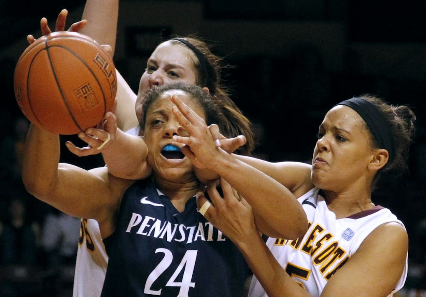 Penn State's Mia Nickson faced her fears, and may have gotten the worst of it when she got caught between 6-7 Gophers center Amber Dvorak, left, and guard Kionna Kellogg in a battle for possession during the Nittany Lions' come-from-behind victory.