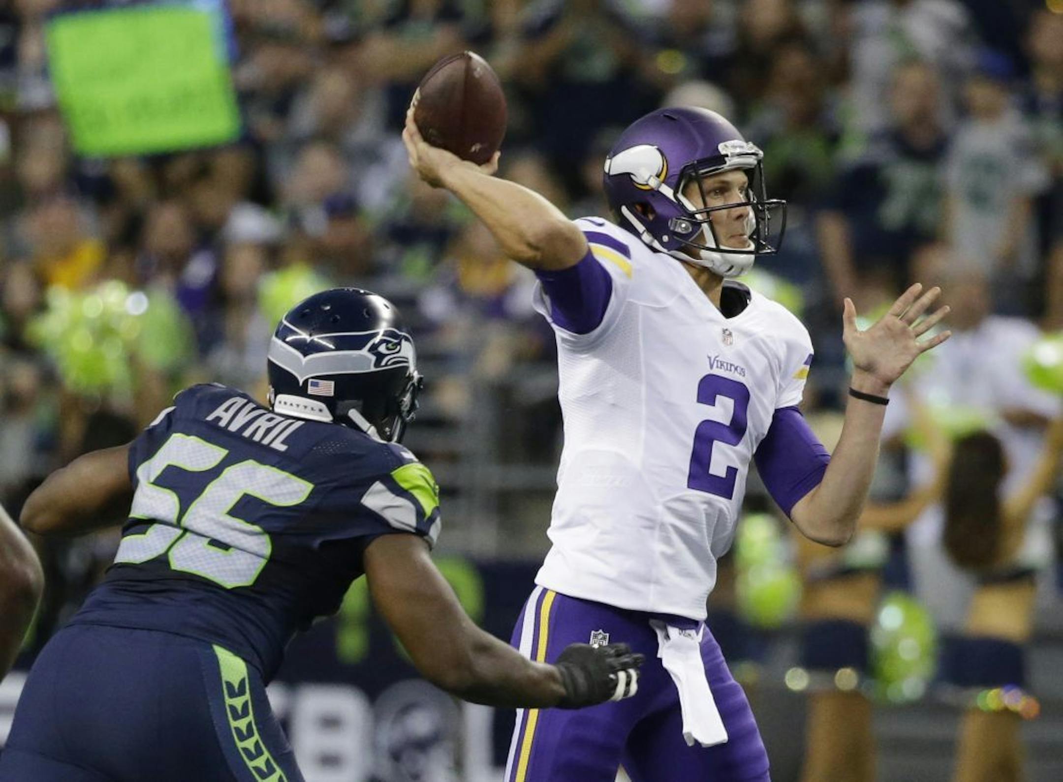 Minnesota Vikings quarterback Joel Stave (2) passes under pressure from Seattle Seahawks defensive end Cliff Avril, left, during the first half of a preseason NFL football game, Thursday, Aug. 18, 2016, in Seattle.