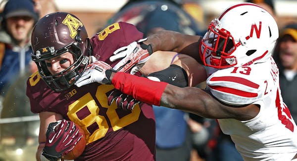 Nebraska?s Zaire Anderson tackles Minnesota Gophers receiver Maxx Williams on 20-yard pass play in the fourth quarter at TCF Bank Stadium in Minneapol