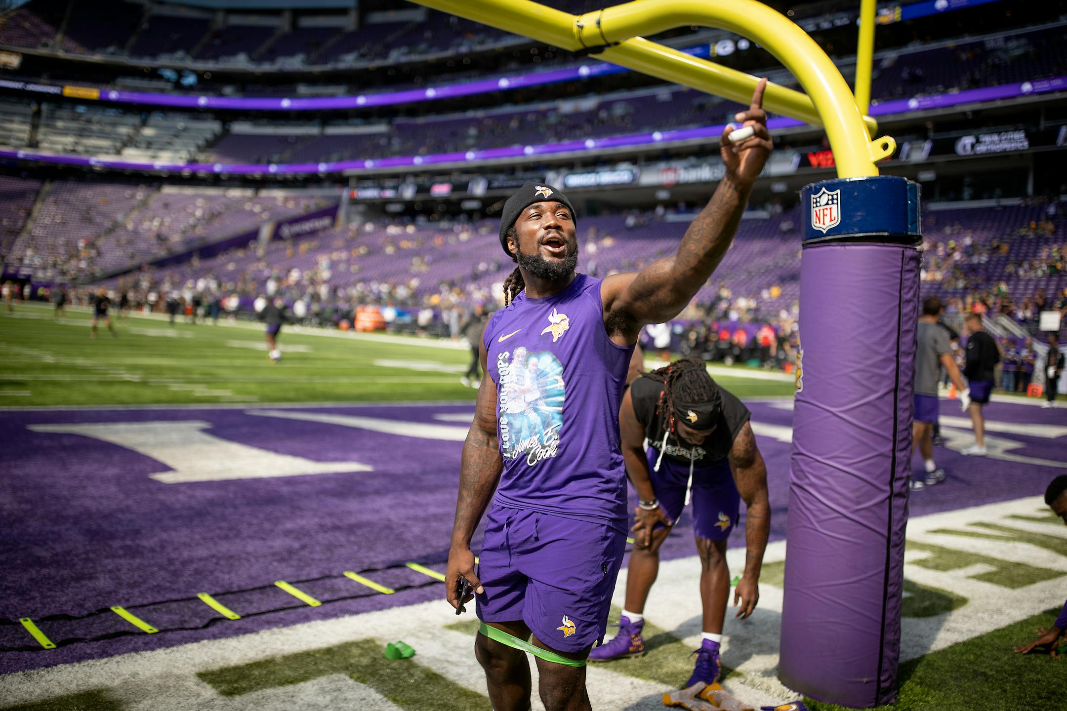 Vikings running back Dalvin Cook (4) yells Happy Birthday to a fan after he warms up on the field.