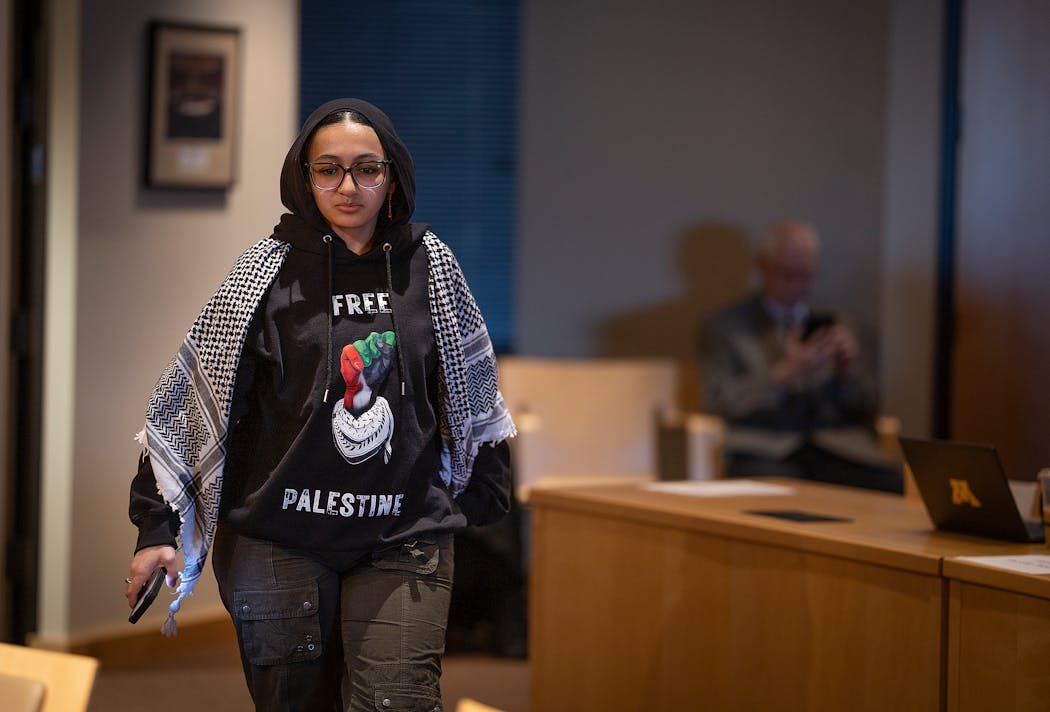 Donia Abu, a student at the University of Minnesota, makes her way to the podium to address the  University of Minnesota Board of Regents during their meeting in on Friday. Abu, who graduates from the university on Sunday, shared that she has lost family members in Palestine.
