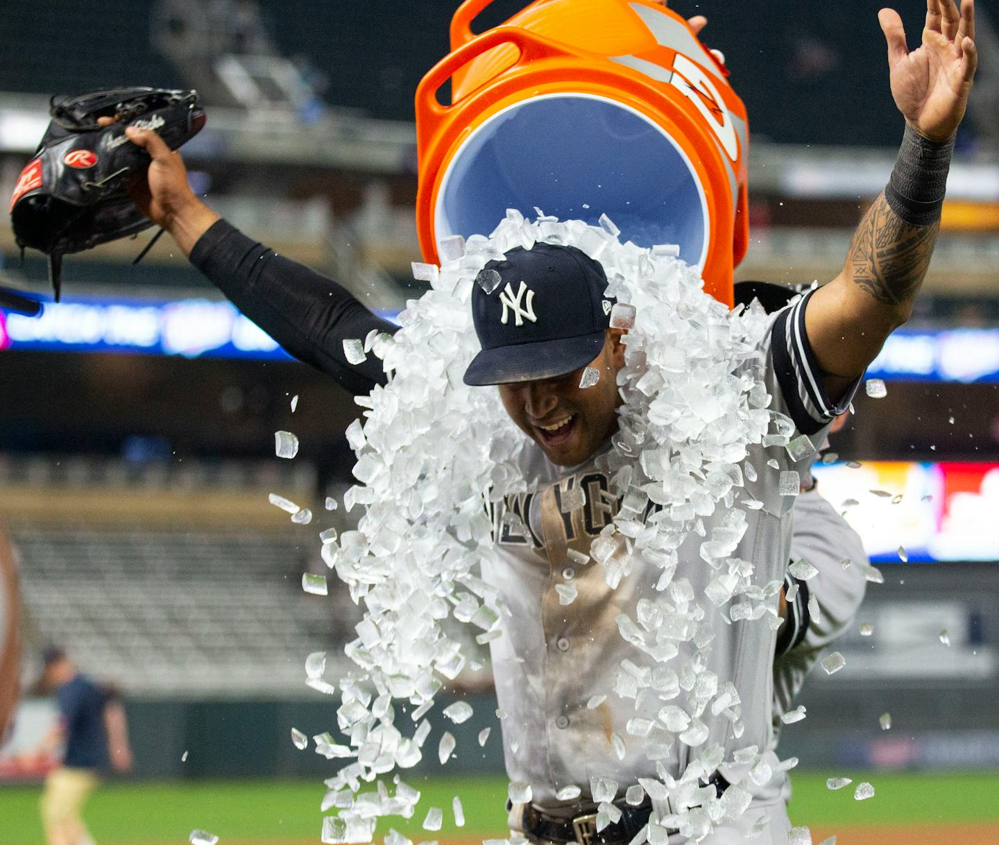 Yankees center fielder Aaron Hicks is doused in an ice bath by a teammate after making the game-winning catch in the bottom of the 10th inning.