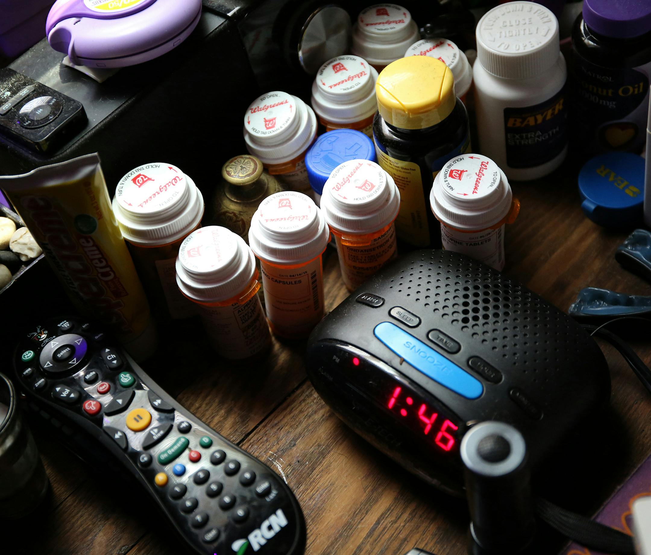 Several containers of medication are laid out beside the bed of Greg Sanchez, who has been living with HIV for 30 years, on Wednesday, June 3, 2015. (Antonio Perez/Chicago Tribune/TNS) ORG XMIT: 1169913
