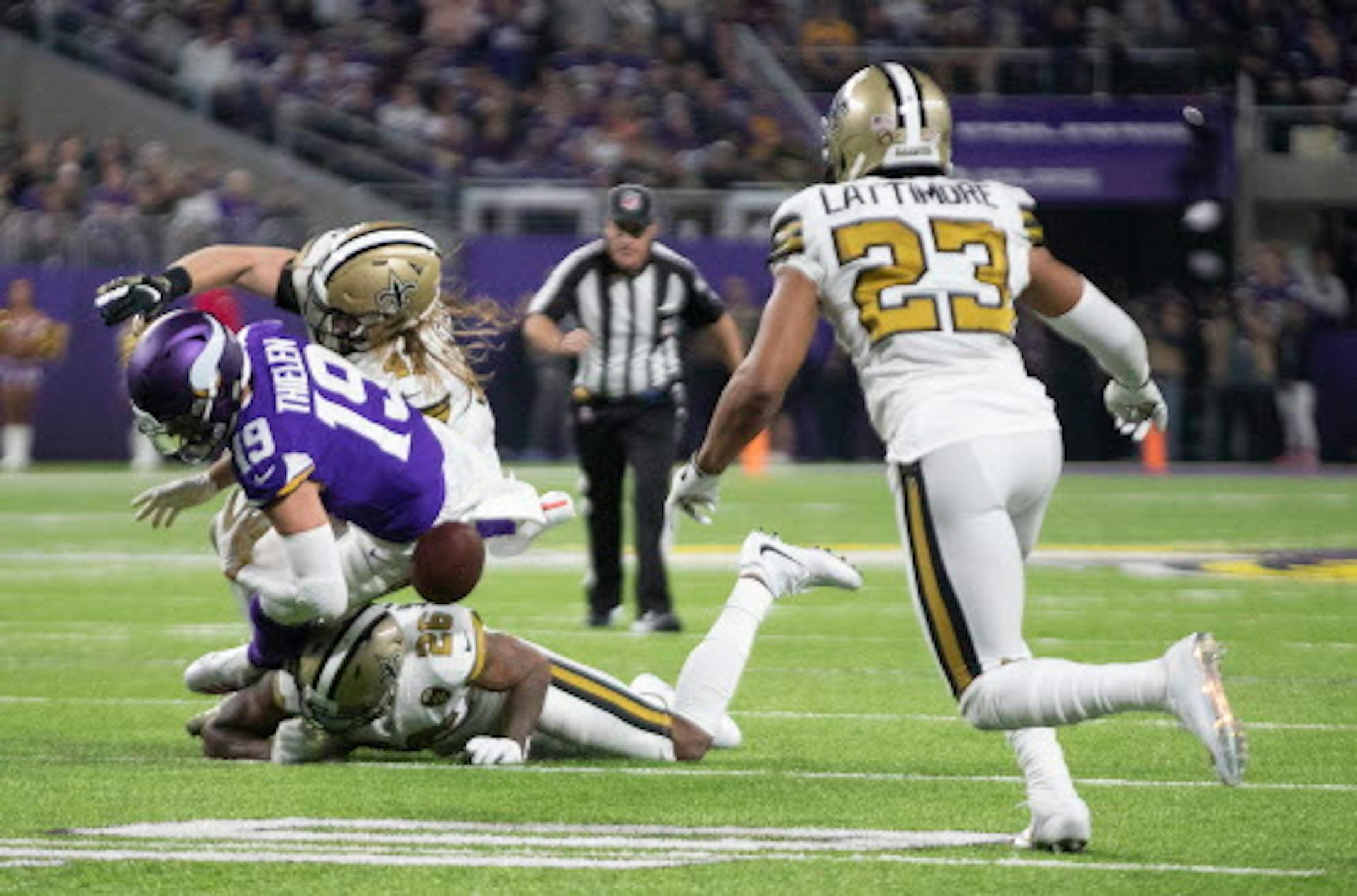 Minnesota Vikings wide receiver Adam Thielen (19) fumbles the ball in the second quarter after he was hit by New Orleans Saints' P.J. Williams on Sunday, Oct. 28, 2018 at U.S. Bank Stadium in Minneapolis, Minn. The fumble was recovered by New Orleans Saints cornerback Marshon Lattimore (23). (Jerry Holt/Minneapolis Star Tribune/TNS) ORG XMIT: 1243950