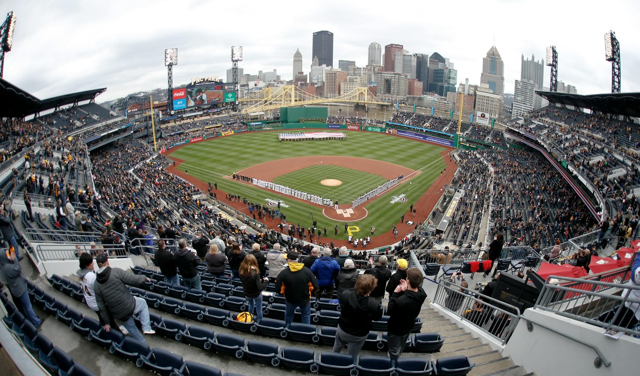 An American flag is unfurled in center field as the national anthem is played at PNC Park before the Pirates' home opener baseball game between the Pittsburgh Pirates and the Minnesota Twins , Monday, April 2, 2018, in Pittsburgh. (AP Photo/Keith Srakocic)