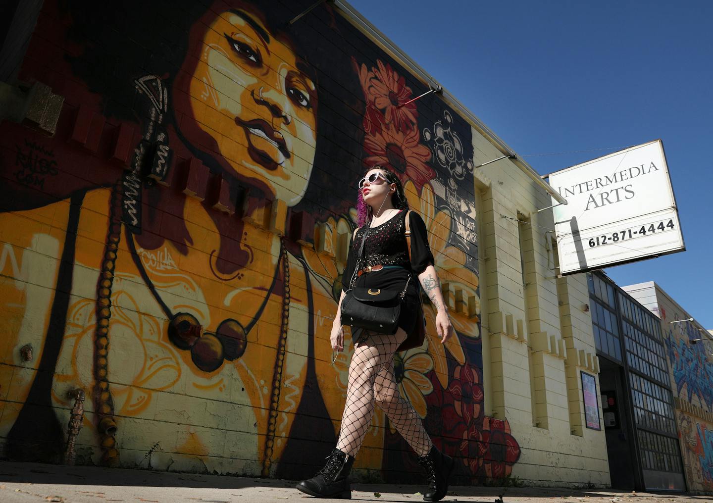 A pedestrian walked past one of the murals that adorns the outside of the Intermedia Arts building Thursday. ] ANTHONY SOUFFLE &#xef; anthony.souffle@startribune.com Intermedia Arts, the Minneapolis theater and gallery space that has long been a mainstay of the arts community, is freezing operations temporarily as it confronts a financial crisis. The venue will reduce its staff by 80 percent and operate on a skeletal basis over the next 90 days. In that time, Intermedia will consider its options