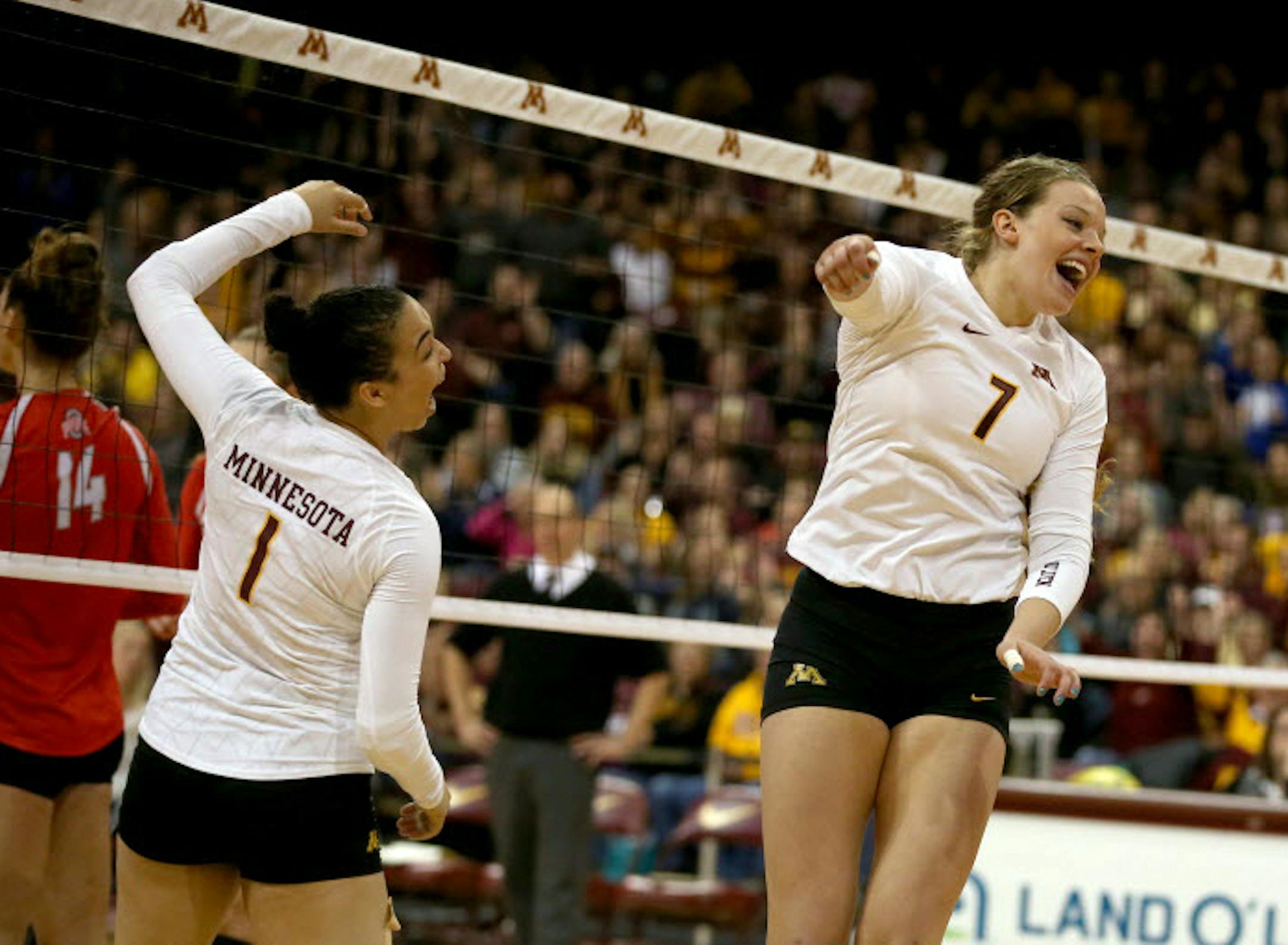 Gophers Daly Santana and Hannah Tapp after making a successful block in the final set of a game against Ohio State.
