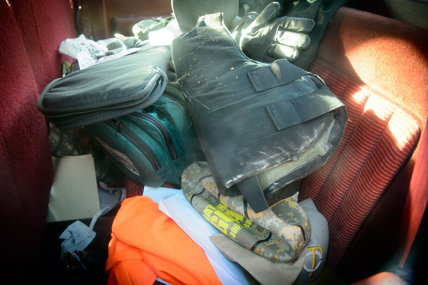 The back seat of Keith Michael Novak GMC pickup truck, pictured in 2013, was packed with fast food wrappers, gun cases and what appeared to be a bulletproof vest and military gear.