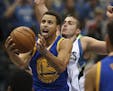 Golden State Warriors guard Stephen Curry (30) put up a second quarter shot past the defense of Timberwolves forward Nemanja Bjelica (88) Thursday nig