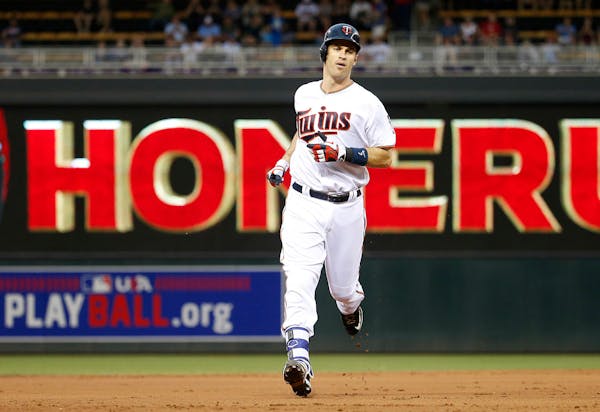 Minnesota Twins' Joe Mauer rounds the bases on his solo home run off Kansas City Royals starting pitcher Ian Kennedy during the first inning of a base