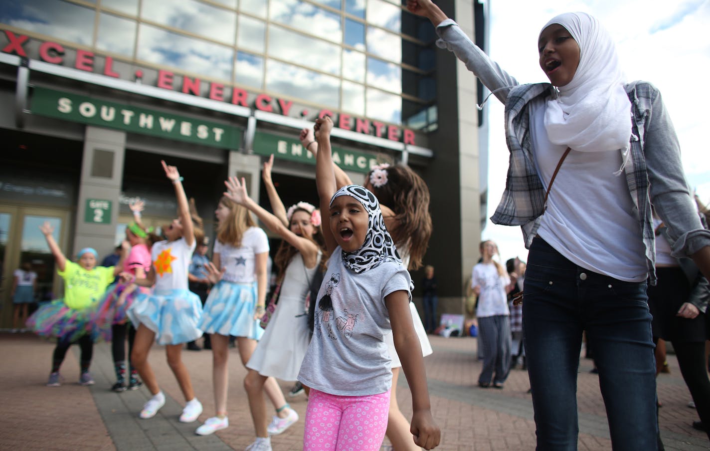 Nasteha Nusa, 8, and sister Najna Dayib, 15, of Bloomington sang and danced with the crowd of fans during the DJ Dance party that was part of the Taylor Swift kick-off party at the Xcel Energy Center in St. Paul.