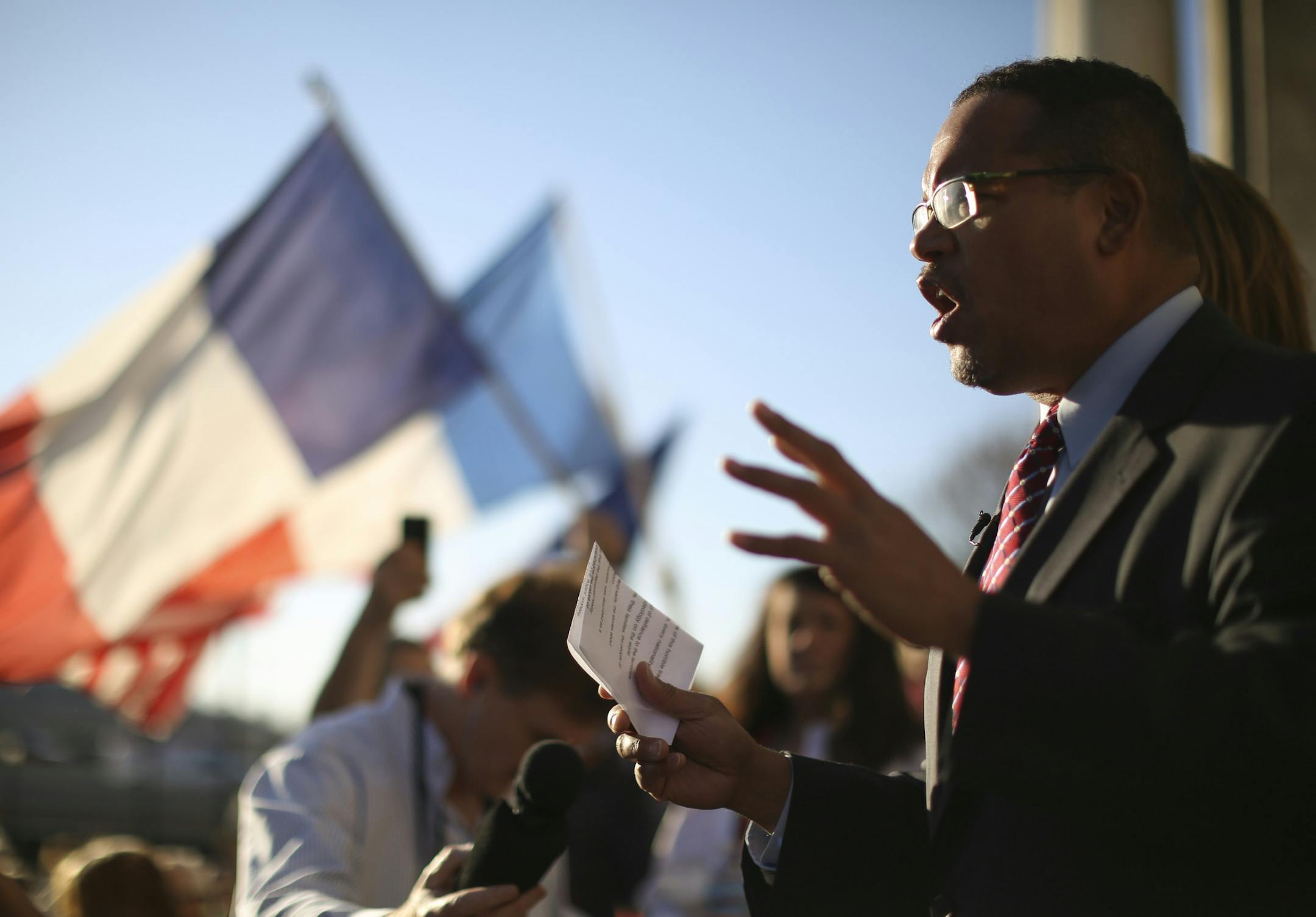 Rep. Keith Ellison, D-Minn., addressed marchers from the steps of the Basilica of St. Mary in Minneapolis before they entered to attend the prayer service Sunday afternoon, saying "I need to be with the people who are grieving loved ones." He also said, of the attackers in France, "These terrorists are insane and demonic."
