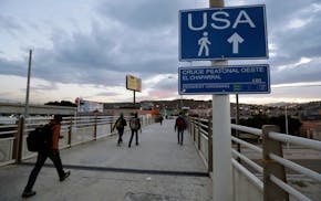 In this 2016 photo, Haitians make their way towards the border crossing in Tijuana, Mexico. The Trump administration is planning to expand the collect