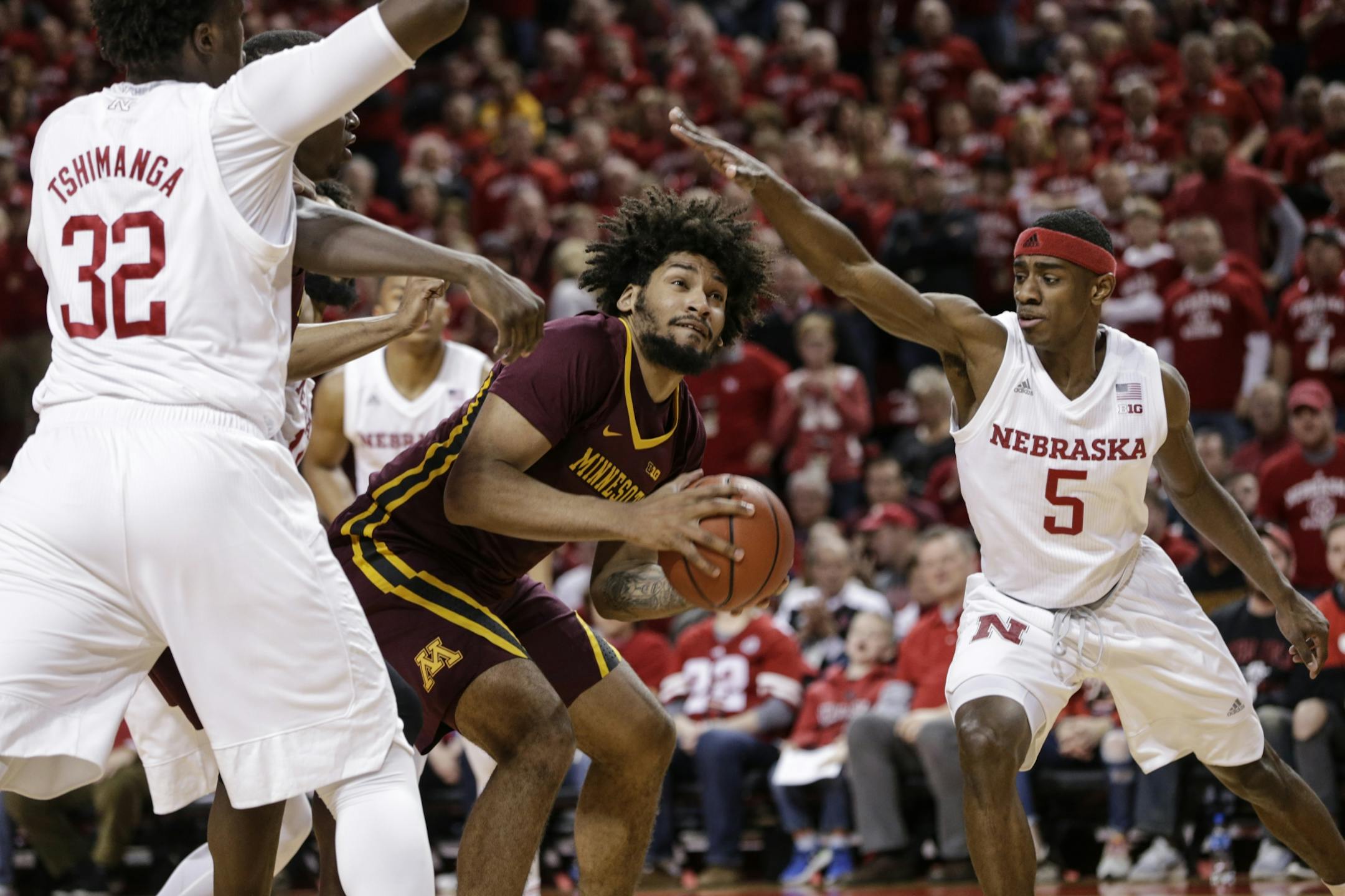 Nebraska's Glynn Watson Jr. (5) and Jordy Tshimanga (32) guard Minnesota's Jordan Murphy (3) during the first half of an NCAA college basketball game in Lincoln, Neb., Tuesday, Dec. 5, 2017.