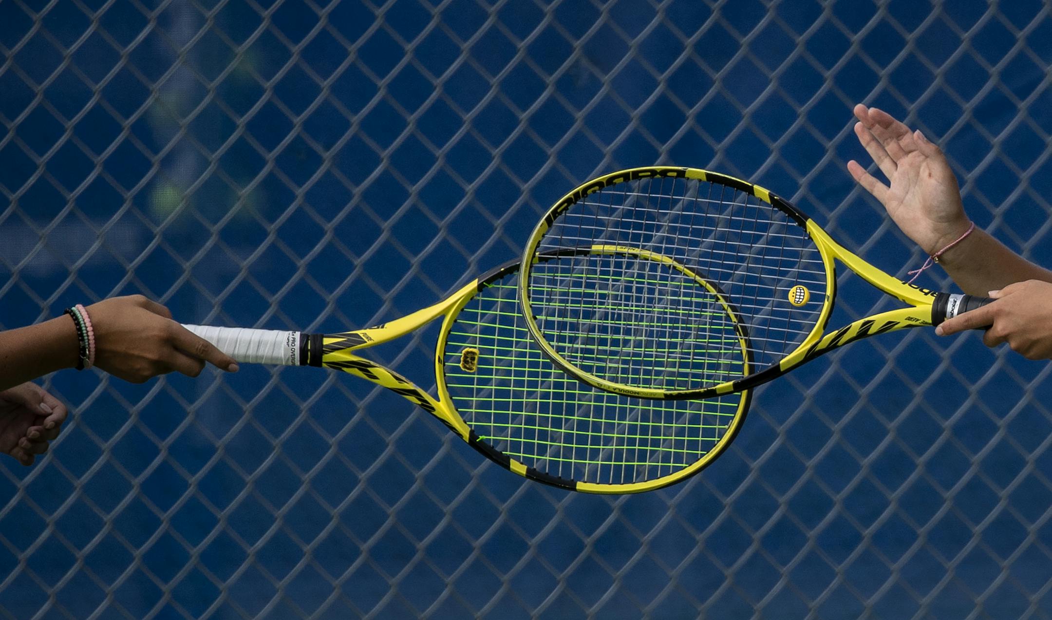 Minnetonka doubles players celebrated with a racket tap during a match vs. Blake. ] CARLOS GONZALEZ • cgonzalez@startribune.com – Minnetonka, MN – August 25, 2020, Blake at Minnetonka Girl's Tennis, two pretty good teams playing early in the season. what's different/same for playing in the age of COVID.