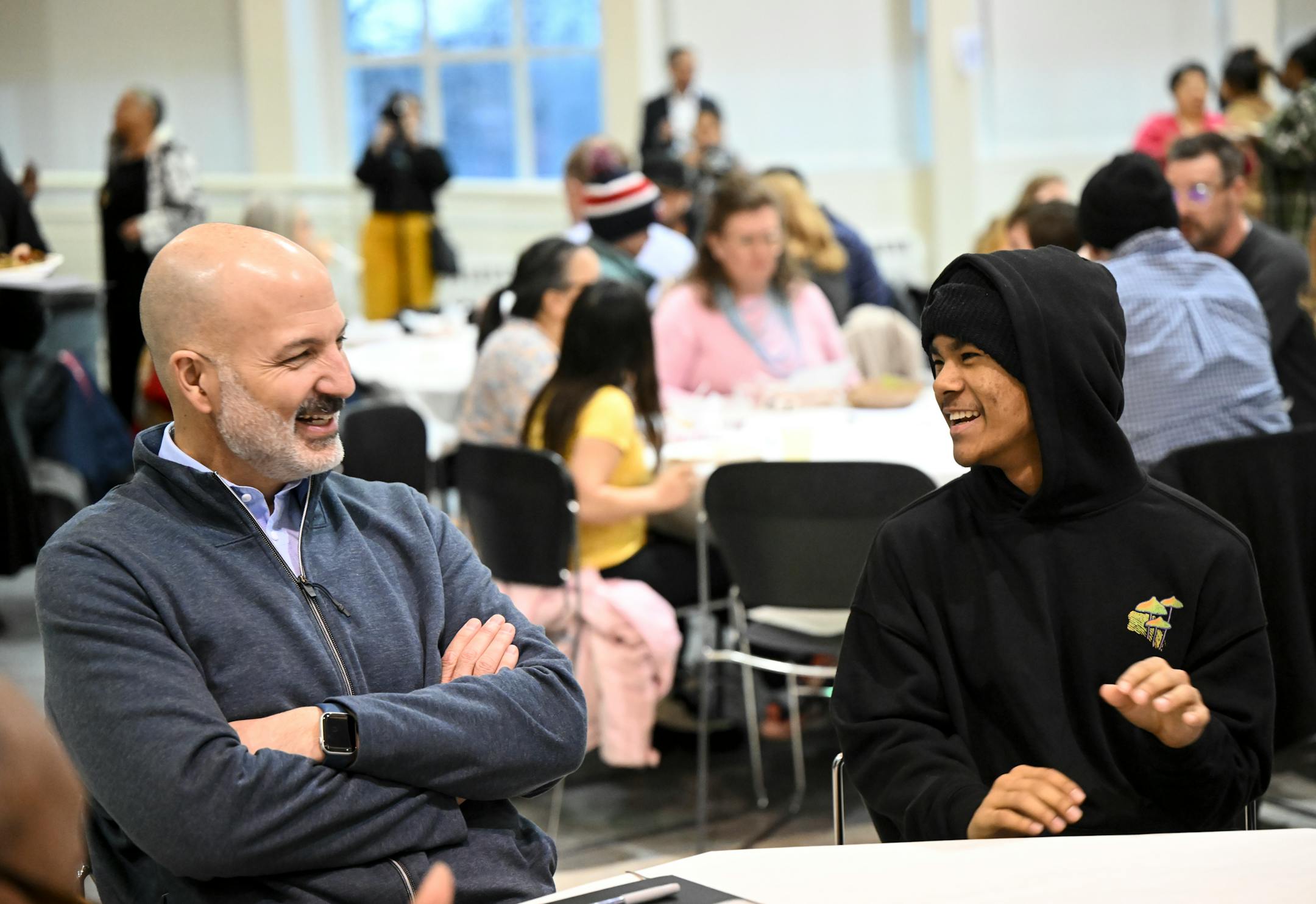 Superintendent Dr. Joe Gothard, left, laughs with Washington student Ujwal Tamang, 15, during an ice breaking exercise.