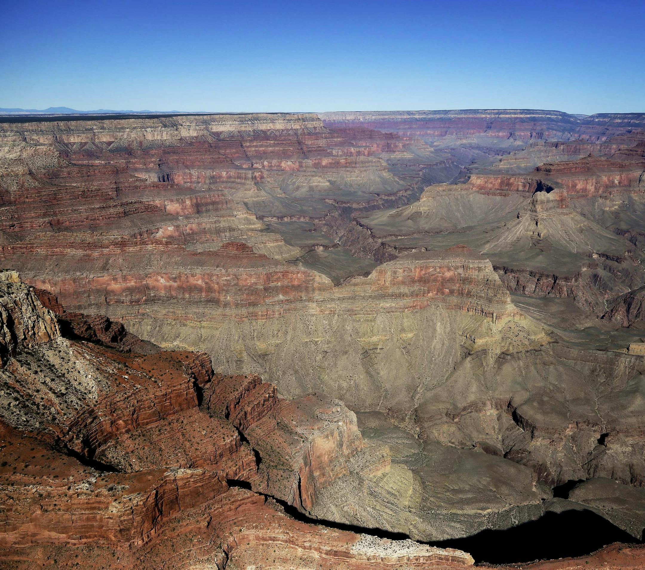 FILE - This Oct. 5, 2013 file photo, the Grand Canyon National Park is covered in the morning sunlight as seen from a helicopter near Tusayan, Ariz. An effort by the Grand Canyon to make a lucrative contract more attractive to bidders means the park will defer planned spending on new lighting, cave monitoring, building a composting toilet and tracking an endangered fish that recently reappeared in the canyon, it was announced Wednesday, Sept. 24, 2014.(AP Photo/Julie Jacobson, File) ORG XMIT: LA