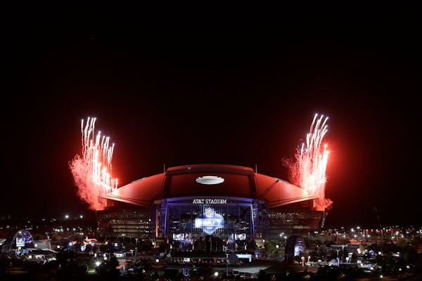 Fireworks are launched outside AT&T Stadium at the conclusion of round three of the NFL Draft
