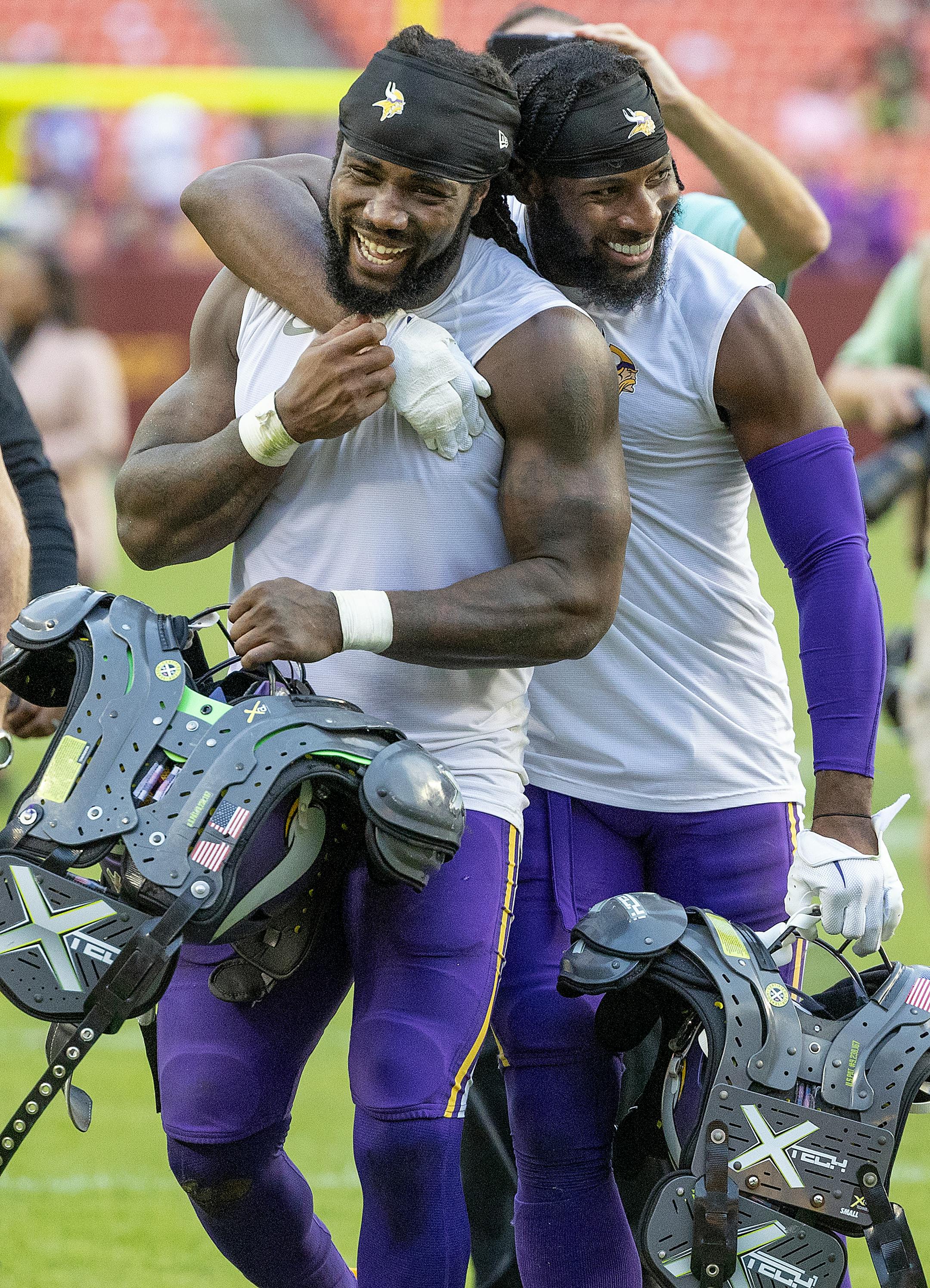 Minnesota Vikings running back Dalvin Cook (4) gets a hug from Vikings cornerback Kris Boyd (29) as they celebrate their 20-17 victory over the Washington Commanders.