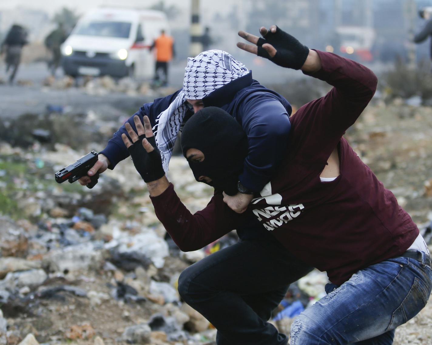 Undercover Israeli police arrest a Palestinian demonstrator during clashes following protests against U.S. President Donald Trump's decision to recognize Jerusalem as the capital of Israel, in the West Bank city of Ramallah, Wednesday, Dec. 13, 2017. (AP Photo/Nasser Shiyoukhi)