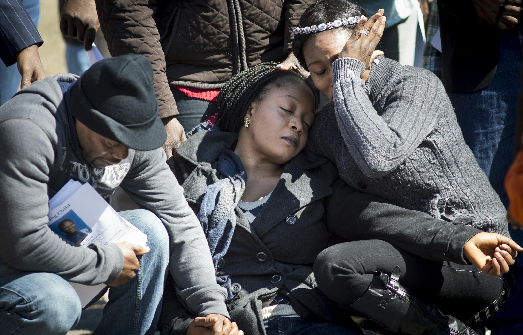 Yamah Collins, center, faints after being overcome with grief during a prayer service marking day 10 of the disappearance of her step son, 10-year old Barway Collins ,in Crystal. To the left, Barway's father Pierre Collins. ] (Aaron Lavinsky | StarTribune) A press conference and prayer service marking day 10 of the disappearance of 10yr old Barway Collins were held on Saturday, March 28, 2015 in Crystal, MN.