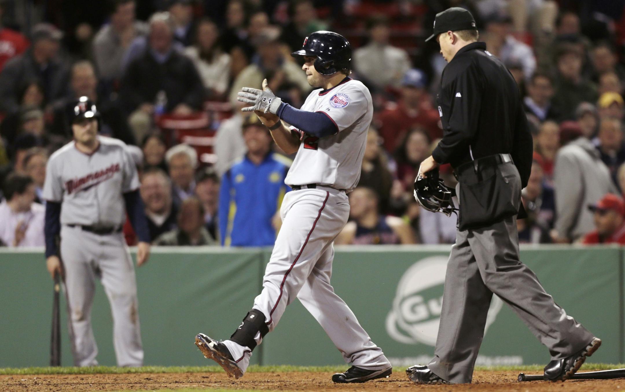 The Twins' Brian Dozier celebrated after crossing home plate following his solo home run during the ninth inning against the Boston Red Sox on Monday. Dozier's homer tied the score at 5-5, but the Red Sox won 6-5 in 11 innings.