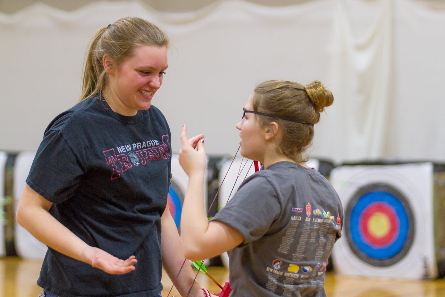 Callie Schroeder, a ninth-grader at New Prague High School, is the 2014 NASP (National Archery in the Schools Program) Minnesota state champion. Her score of 294 out of a possible 300, a personal best, was the highest among the more than 1,100 boys and girls grades 4-12 at the state tournament in Champlin in March. In this photo, Callie, left, practices with teammate and friend Bella Schulte. Photo by Mark Hvidsten