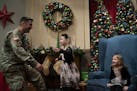 Olivia Guptill ran to hug her dad, Capt. Steven Guptill when he surprised her and her sister, Caitlyn, 5, during their annual visit with Santa Claus W