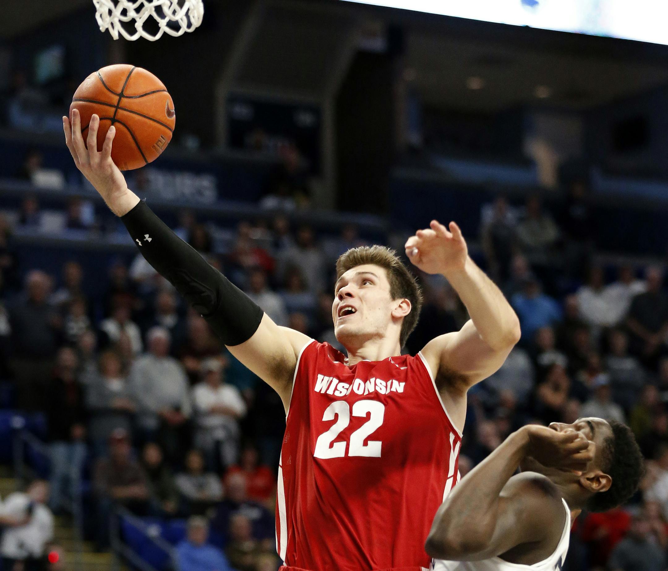Wisconsin's Ethan Happ (22) goes to the basket over Penn State's Mike Watkins (24) during first half action of an NCAA college basketball game in State College, Pa. Sunday, Jan. 6, 2019. (AP Photo/Chris Knight)