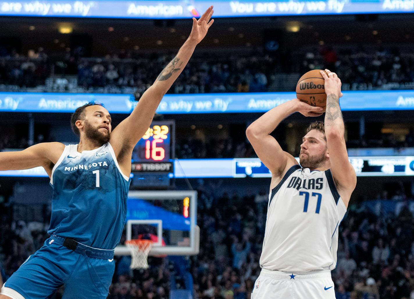 Dallas Mavericks guard Luka Doncic (77) puts up a 3-point basket over Minnesota Timberwolves forward Kyle Anderson (1) during the first half of an NBA basketball game Sunday, Jan. 7, 2024, in Dallas. (AP Photo/Jeffrey McWhorter)