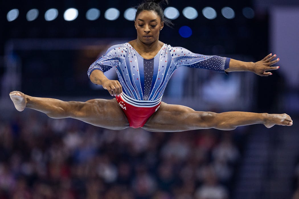 Simone Biles leaps into a split in a beam routine during the first night of women's competition in the U.S. gymnastics Olympic trials at Target Center Friday.