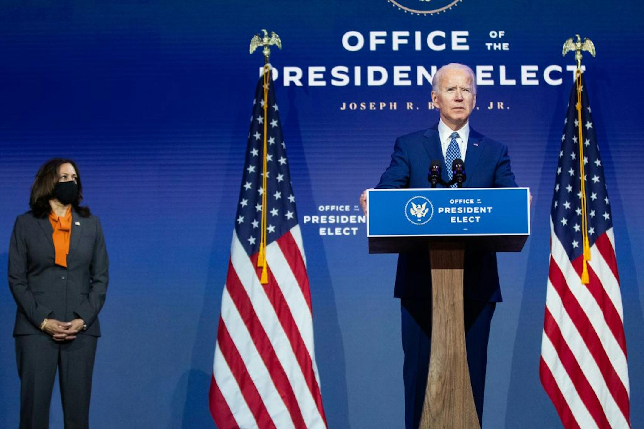 President-elect Joe Biden speaks about the coronavirus at The Queen theater in Wilmington, Del., Nov. 9, 2020, as Vice President-elect Kamala Harris looks on. Prime Minister Boris Johnson is in the final phases of trying to negotiate a post-Brexit trade agreement with the European Union, a complex challenge that just became more urgent with the defeat of his ally and ideological mate, President Donald Trump.
