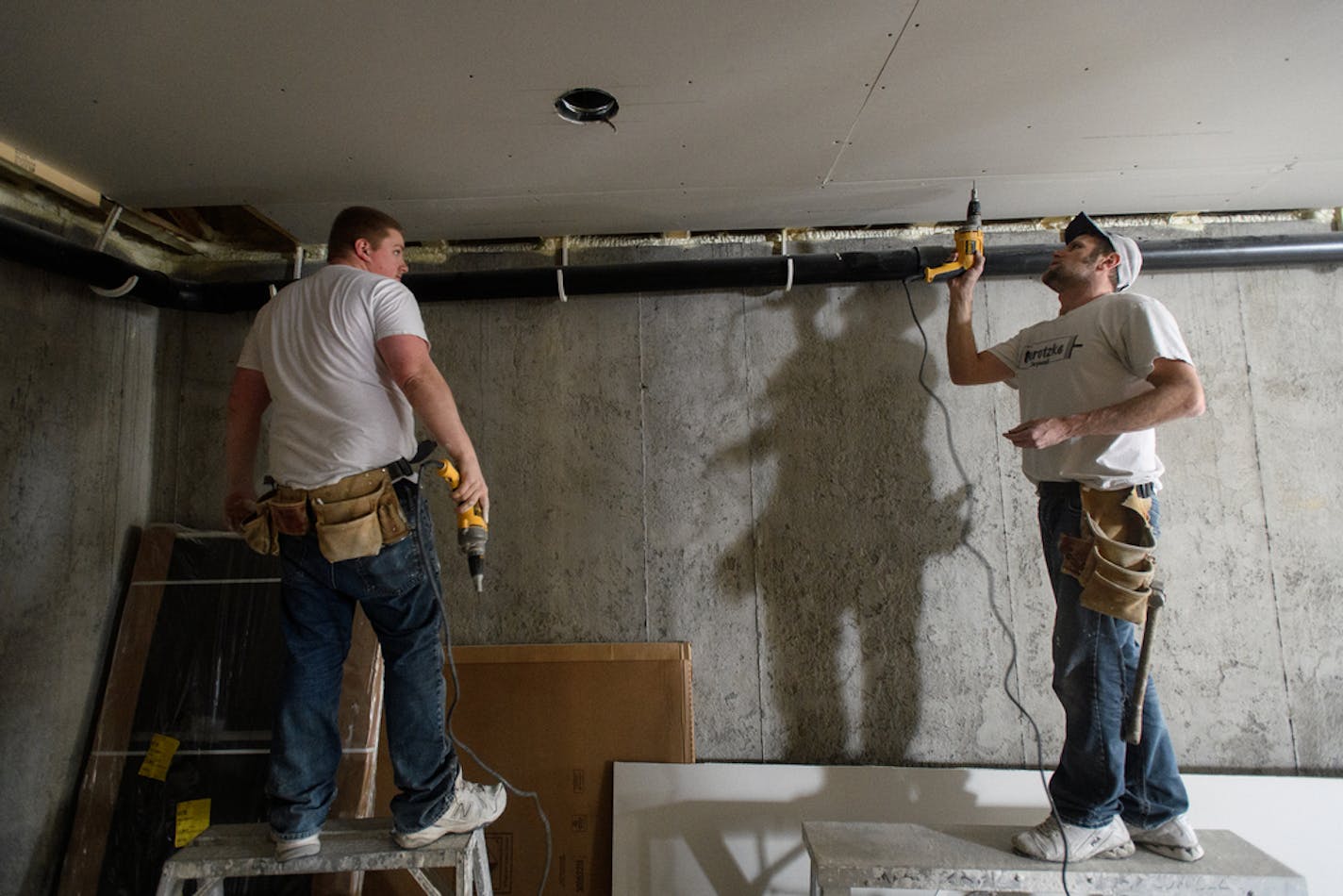 Contractors Mike Marotzke, left, and Doug DeFlorin installed Sheetrock in an almost-finished home in northeast Minneapolis in 2017.