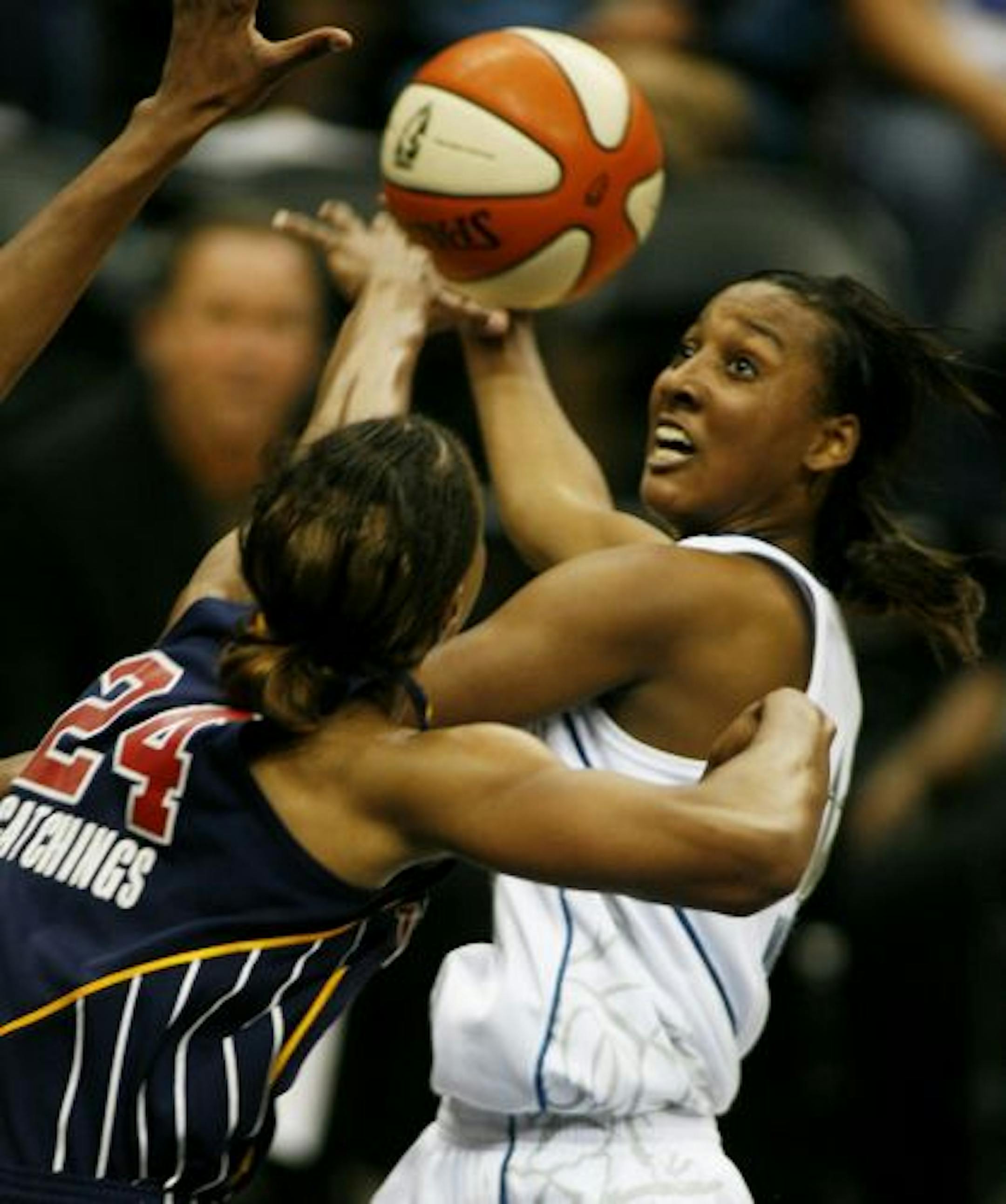 Candice Wiggins of the Lynx hit an improbable driving shot over the Indiana Fever's Tamika Catchings during the first quarter at Target Center in Minneapolis.