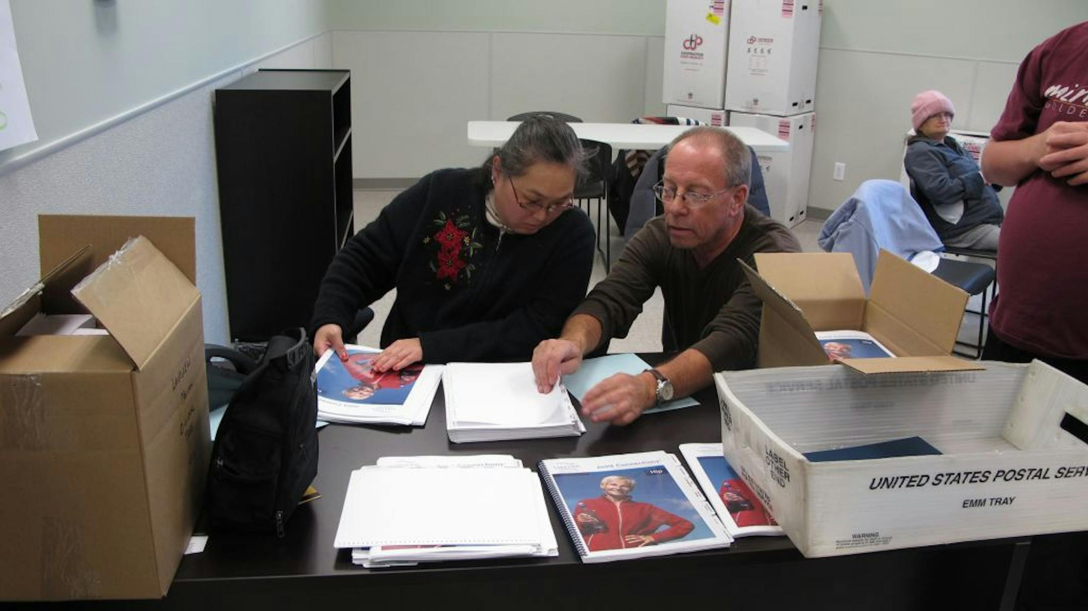 East Suburban Resources' Tim Pietraszewski showed a worker how to assemble a booklet on hip surgery that will be used at Lakeview Hospital.
