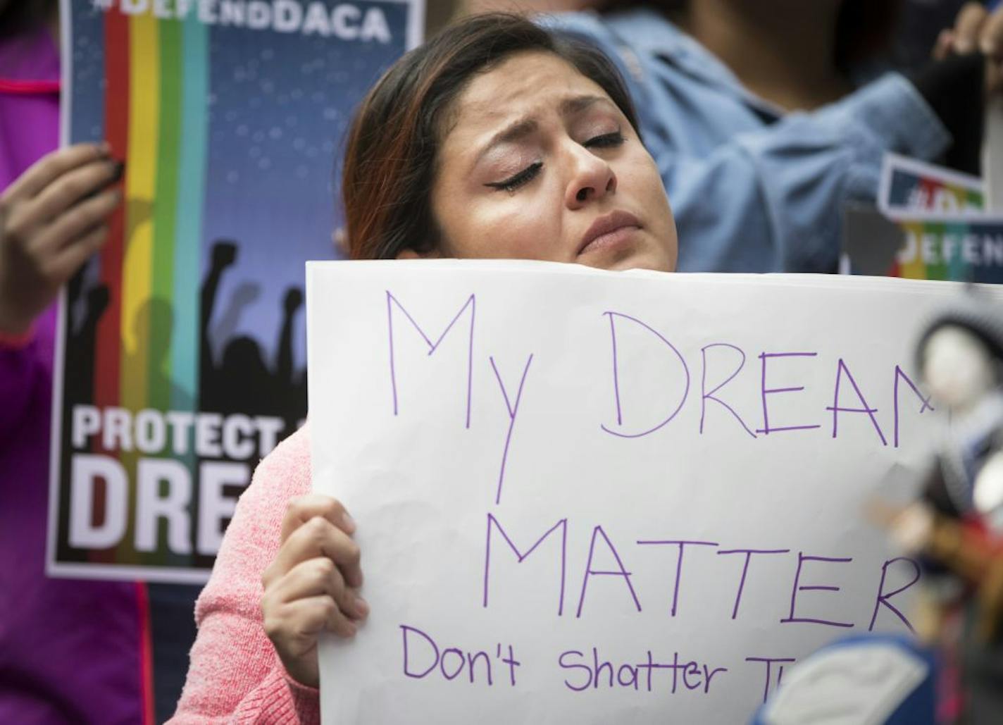 Evelin Hernandez, 27, cried as she held a sign reading "My dreams matter. don't shatter them," during a protest in front of the Hennepin County Jail after President Donald Trump announced his plans to rescind DACA on Tuesday, September 5, 2017, Minneapolis, Minn. Hernandez is a special education paraprofessional and a dream act recipient.