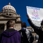 People gather in front of the Idaho Statehouse in opposition to anti-transgender legislation moving through an Idaho Republican congress, Friday, Feb.