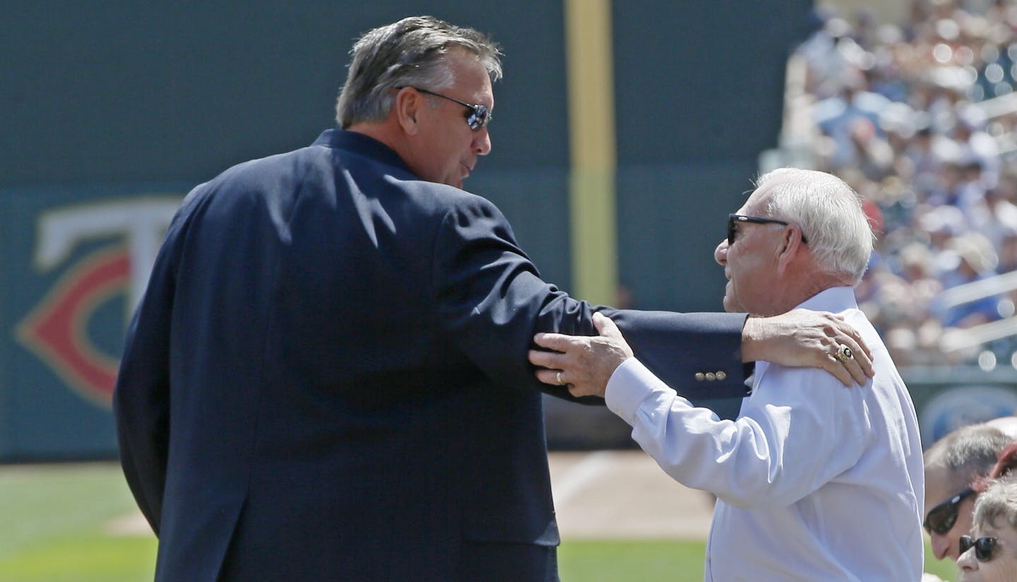 Minnesota Twins' Kent Hrbek, left, congratulates Jerry Bell during induction ceremonies for Bell, former president of the Twins, into the Twins Hall of Fame prior to a baseball game against the Kansas City Royals Sunday, Aug. 4, 2019, in Minneapolis. (AP Photo/Jim Mone)