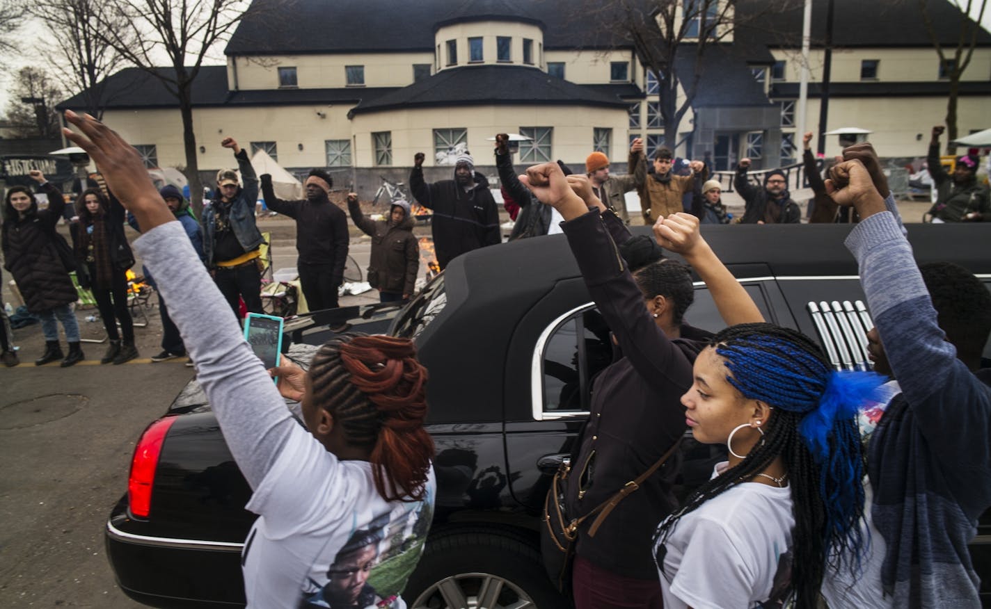 At the funeral procession for Jamar Clark at the Police 4th Precinct, family members got out of the limousine to show support for the Black Lives Matter supporters.